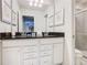 Bright bathroom with a double vanity and a granite countertop with framed art on the wall at 8844 Corcovado Dr, Kissimmee, FL 34747