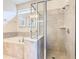 Bright bathroom with a glass-enclosed shower, soaking tub, and neutral tile throughout at 8844 Corcovado Dr, Kissimmee, FL 34747
