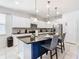 Bright kitchen with granite countertops, pendant lighting over island, stainless steel appliances, and white cabinets at 8844 Corcovado Dr, Kissimmee, FL 34747
