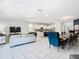 Open concept living space features a dining room, kitchen, and living room with ample seating at 8844 Corcovado Dr, Kissimmee, FL 34747