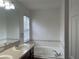 Bathroom featuring a vanity and a soaking tub near a window at 14460 Clarkson Dr, Orlando, FL 32828