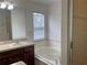 Bathroom showcasing a double sink vanity, tub, separate shower, and ample natural light creating a serene space at 14460 Clarkson Dr, Orlando, FL 32828