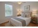 Light bedroom with a window, plush bedding, and bedside tables at 14460 Clarkson Dr, Orlando, FL 32828