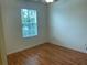 A bedroom with a ceiling fan, wood-look floors, and a window, offering a cozy and relaxing retreat within the home at 14460 Clarkson Dr, Orlando, FL 32828
