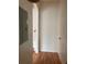 Hallway featuring hardwood floors, stairs, and a neutral color palette at 14460 Clarkson Dr, Orlando, FL 32828