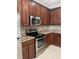 Kitchen featuring stainless steel oven and microwave, and granite countertops at 14460 Clarkson Dr, Orlando, FL 32828