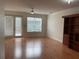 Open living room featuring a ceiling fan, wood-look flooring, and natural light at 14460 Clarkson Dr, Orlando, FL 32828