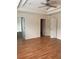 Spacious bedroom featuring wood floors, a ceiling fan, and ensuite bath with dual-sink vanities at 14460 Clarkson Dr, Orlando, FL 32828