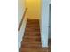Carpeted staircase with wood railing at 14460 Clarkson Dr, Orlando, FL 32828