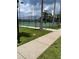 Exterior view of a community tennis court surrounded by mature trees and a black chain-link fence at 14460 Clarkson Dr, Orlando, FL 32828