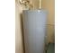Image shows a gray residential water heater with visible pipes and connections in a utility area at 14460 Clarkson Dr, Orlando, FL 32828