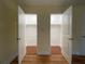 Bedroom doorway reveals two walk-in closets with wood flooring and ample storage space at 2432 Lemon Tree Ln # B, Orlando, FL 32839