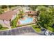 Aerial view of the community pool with lounge chairs and landscaping at 2432 Lemon Tree Ln # B, Orlando, FL 32839