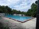 Community pool surrounded by concrete deck at 2432 Lemon Tree Ln # B, Orlando, FL 32839