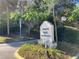 Entrance to Lemon Tree Condominiums community featuring sign with lush greenery and street lamp at 2432 Lemon Tree Ln # B, Orlando, FL 32839