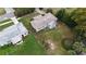 Aerial view of a home with a spacious backyard and an adjacent home with a lovely green lawn at 2819 Pembrook Dr, Orlando, FL 32810