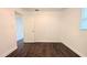 Bedroom featuring dark wood floors, a window, and a door to another room at 2819 Pembrook Dr, Orlando, FL 32810