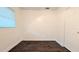 Bright bedroom featuring dark wood floors, a window with blinds, and a white door at 2819 Pembrook Dr, Orlando, FL 32810