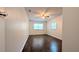 Neutral bedroom showcasing a ceiling fan, hardwood flooring, and bright windows at 2819 Pembrook Dr, Orlando, FL 32810