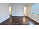 Spacious bedroom with dark wood floors, neutral walls, and ample natural light at 2819 Pembrook Dr, Orlando, FL 32810