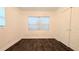 An empty room featuring hard wood floors, a window and a closet at 2819 Pembrook Dr, Orlando, FL 32810