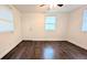 A room featuring hardwood flooring, a window, and a door at 2819 Pembrook Dr, Orlando, FL 32810