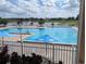 Refreshing community pool with lake view and lounge chairs at 6147 Sunnyvale Dr, Orlando, FL 32822