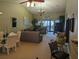 Open living and dining area with large windows and patio access at 6147 Sunnyvale Dr, Orlando, FL 32822