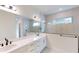 Bathroom features a double sink vanity, and a glass enclosed shower with white subway tile at 10257 Medawar St, Orlando, FL 32827