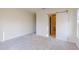 Bedroom features carpet flooring, neutral walls and a sliding barn door to the bath at 10257 Medawar St, Orlando, FL 32827