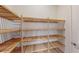 Walk-in closet with natural wood shelving and ample storage space at 10257 Medawar St, Orlando, FL 32827