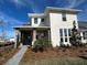 Two-story house with light beige siding, stone accents, and a landscaped yard at 10257 Medawar St, Orlando, FL 32827