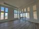 Spacious living room with hardwood floors and large windows providing ample natural light at 10257 Medawar St, Orlando, FL 32827