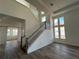 Modern staircase with wooden handrail leading to the second floor at 10257 Medawar St, Orlando, FL 32827