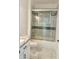 This bathroom has an updated shower with glass doors and modern tilework at 17271 E Peggy Ave. Ave, Mount Dora, FL 32757
