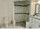 Newly remodeled bathroom with walk-in shower featuring marble tile and gray and green accent at 17271 E Peggy Ave. Ave, Mount Dora, FL 32757