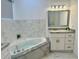 Bathroom featuring a garden tub, gray granite countertops, and modern lighting at 17271 E Peggy Ave. Ave, Mount Dora, FL 32757