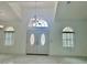 Bright entryway featuring marble floors, double doors, and a chandelier under the tray ceiling at 17271 E Peggy Ave. Ave, Mount Dora, FL 32757