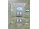 Bright entryway featuring marble floors, double doors, and a chandelier under the tray ceiling at 17271 E Peggy Ave. Ave, Mount Dora, FL 32757