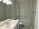 Bathroom with white vanity, tub, and tile floor at 2463 Francisco Art Ct, Oviedo, FL 32765