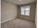 Bright bedroom with neutral walls and carpeted floors and a window at 2463 Francisco Art Ct, Oviedo, FL 32765