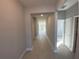 Long hallway with light walls and tile floors at 2463 Francisco Art Ct, Oviedo, FL 32765