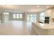 Open living room and kitchen area with light flooring and access to backyard at 2463 Francisco Art Ct, Oviedo, FL 32765