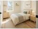 Cozy bedroom features light hardwood floors, natural light, a decorative print, and a peaceful atmosphere at 4058 Sw 167Th St, Ocala, FL 34473