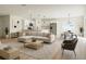 Open-concept living area features a large sofa, modern decor, and seamless flow into the kitchen and dining area at 4058 Sw 167Th St, Ocala, FL 34473