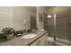 Bathroom features granite counters, a vessel sink, a large mirror, and a glass-enclosed shower at 7554 Marker Ave, Kissimmee, FL 34747