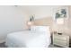 Cozy bedroom featuring neutral decor, a tufted headboard, and bedside tables with stylish lamps at 7554 Marker Ave, Kissimmee, FL 34747