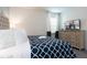 Comfortable bedroom features a queen-sized bed, stylish decor, and an entertainment center at 7554 Marker Ave, Kissimmee, FL 34747