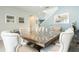 Elegant dining room with a glass-top table, seating for ten, and stylish modern decor at 7554 Marker Ave, Kissimmee, FL 34747