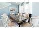 Elegant dining room with a glass-top table, seating for ten, and stylish modern decor at 7554 Marker Ave, Kissimmee, FL 34747